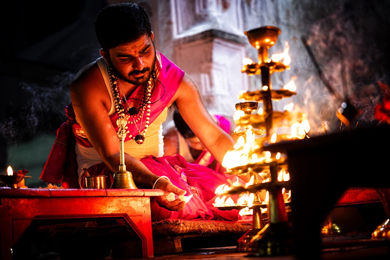 Hindu priest conducting a traditional ritual ceremony with candles and incense in Deoghar, Jharkhand, India.